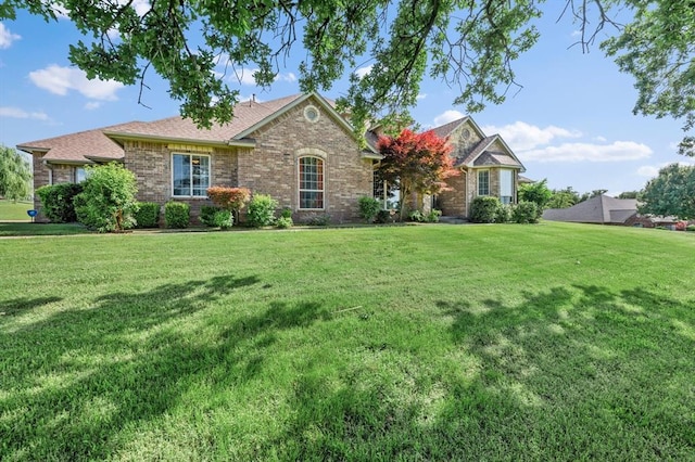 5420 NE 56th St, Oklahoma City, OK 73121 - view of front of home featuring brick siding, a front lawn, and roof with shingles