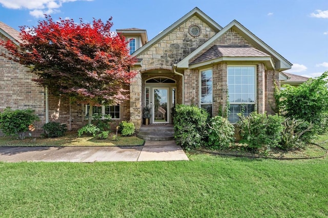 5420 NE 56th St, Oklahoma City, OK 73121 - view of front of home featuring a front lawn, brick siding, and stone siding