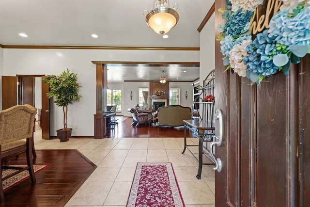 5420 NE 56th St, Oklahoma City, OK 73121 - tiled foyer with ornamental molding, a fireplace, and recessed lighting