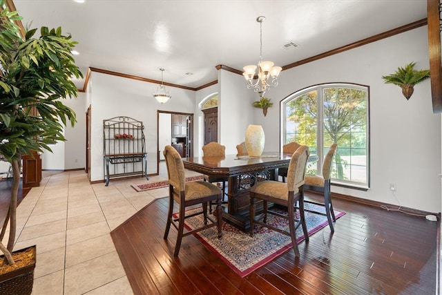 5420 NE 56th St, Oklahoma City, OK 73121 - dining area featuring a chandelier, ornamental molding, and light wood-type flooring