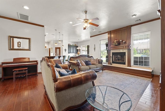 5420 NE 56th St, Oklahoma City, OK 73121 - living room featuring ceiling fan, ornamental molding, a fireplace, dark wood finished floors, and recessed lighting