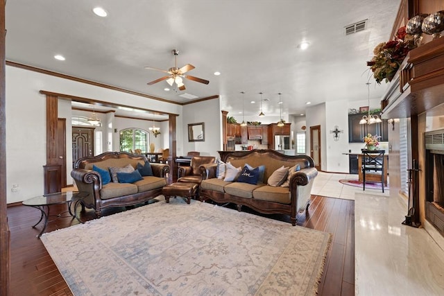 5420 NE 56th St, Oklahoma City, OK 73121 - living area featuring a chandelier, ceiling fan, light wood-style flooring, ornamental molding, and recessed lighting