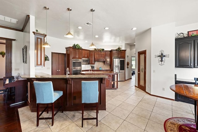 5420 NE 56th St, Oklahoma City, OK 73121 - kitchen featuring stainless steel appliances, a kitchen breakfast bar, a peninsula, light stone counters, and recessed lighting