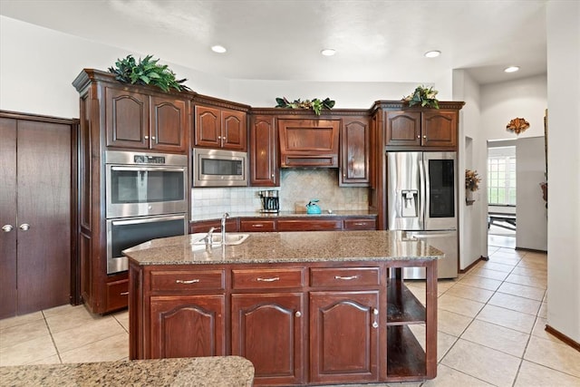 5420 NE 56th St, Oklahoma City, OK 73121 - kitchen with stainless steel appliances, light tile patterned flooring, decorative backsplash, light stone countertops, and recessed lighting