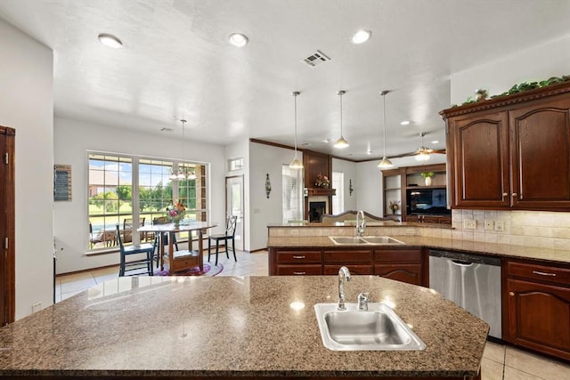5420 NE 56th St, Oklahoma City, OK 73121 - kitchen with dishwasher, a peninsula, a kitchen island with sink, light tile patterned floors, and backsplash