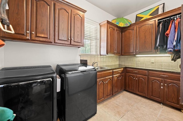 5420 NE 56th St, Oklahoma City, OK 73121 - washroom featuring cabinet space, light tile patterned floors, and independent washer and dryer