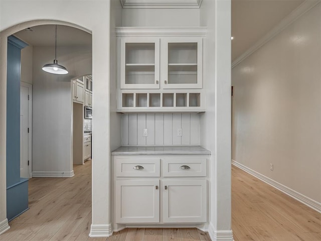 8408 NW 134th St, Oklahoma City, OK 73142 - detailed view of arched walkways, wood finished floors, ornamental molding, and stainless steel microwave