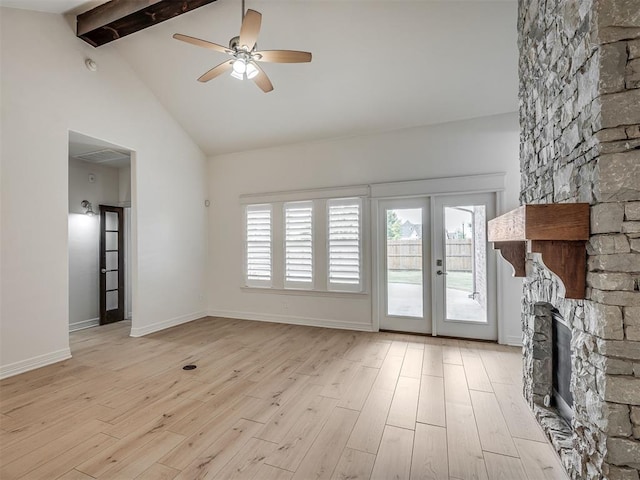 8408 NW 134th St, Oklahoma City, OK 73142 - unfurnished living room featuring beamed ceiling, light wood-style flooring, a stone fireplace, ceiling fan, and high vaulted ceiling