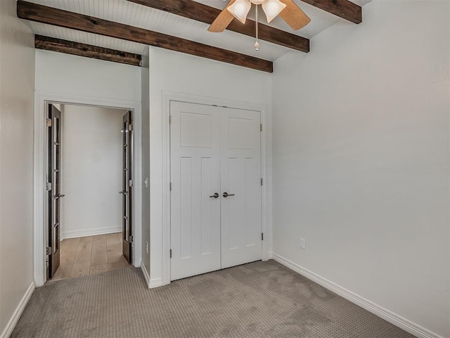 8408 NW 134th St, Oklahoma City, OK 73142 - unfurnished bedroom featuring carpet floors, beamed ceiling, a closet, and a ceiling fan