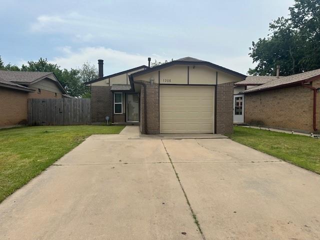 1208 SW 21st St, Oklahoma City, OK 73170 - view of front of property featuring driveway, an attached garage, and brick siding