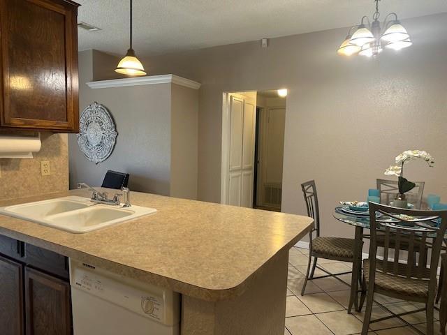 1208 SW 21st St, Oklahoma City, OK 73170 - kitchen featuring dishwasher, decorative light fixtures, light tile patterned flooring, light countertops, and a peninsula