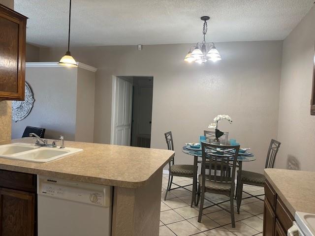 1208 SW 21st St, Oklahoma City, OK 73170 - kitchen featuring white dishwasher, a chandelier, light countertops, decorative light fixtures, and a textured ceiling