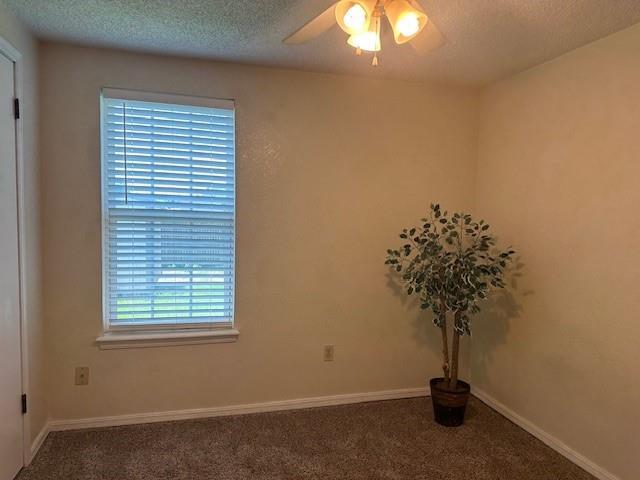 1208 SW 21st St, Oklahoma City, OK 73170 - empty room with carpet floors, a textured ceiling, and a ceiling fan