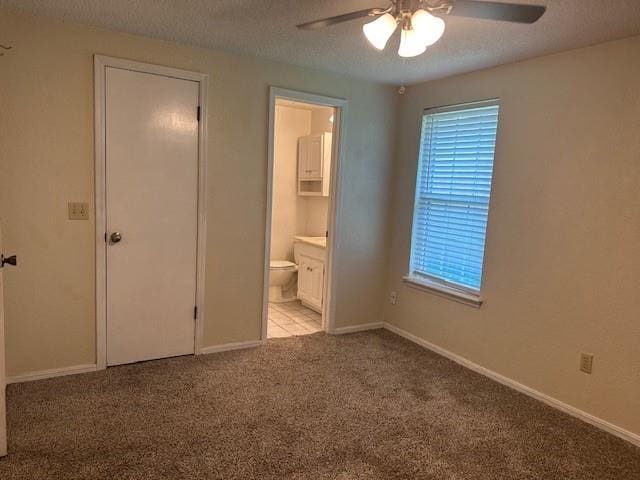 1208 SW 21st St, Oklahoma City, OK 73170 - unfurnished bedroom featuring carpet, ensuite bathroom, a textured ceiling, and a ceiling fan