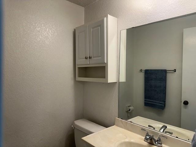 1208 SW 21st St, Oklahoma City, OK 73170 - half bathroom with a textured wall and vanity