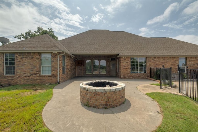 4120 S Choctaw Rd, Choctaw, OK 73020 - rear view of house featuring a fire pit, roof with shingles, brick siding, and a patio