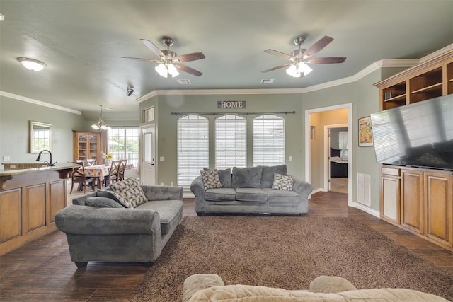 4120 S Choctaw Rd, Choctaw, OK 73020 - living area featuring a chandelier, dark wood finished floors, ornamental molding, and a ceiling fan