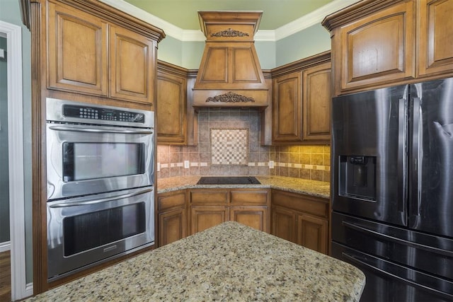 4120 S Choctaw Rd, Choctaw, OK 73020 - kitchen featuring refrigerator with ice dispenser, stainless steel double oven, black electric stovetop, brown cabinetry, and ornamental molding