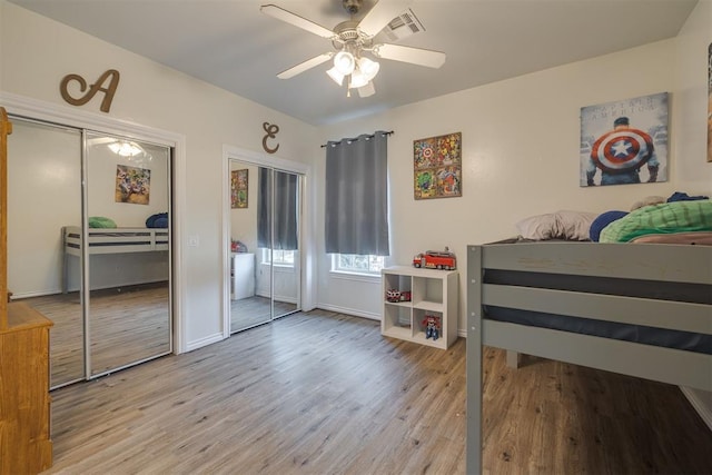 4120 S Choctaw Rd, Choctaw, OK 73020 - bedroom with two closets, light wood-style floors, and ceiling fan