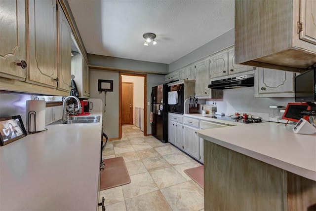 881 County St Unit 2938, Tuttle, OK 73089 - kitchen with under cabinet range hood, black appliances, light countertops, and a textured ceiling