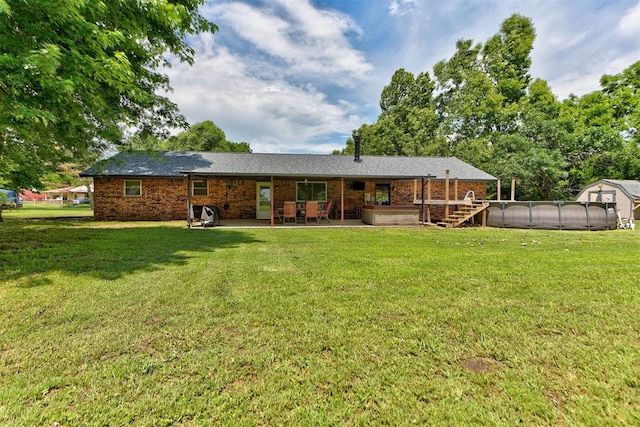 881 County St Unit 2938, Tuttle, OK 73089 - rear view of house with a greenhouse, a patio, a yard, an outbuilding, and brick siding