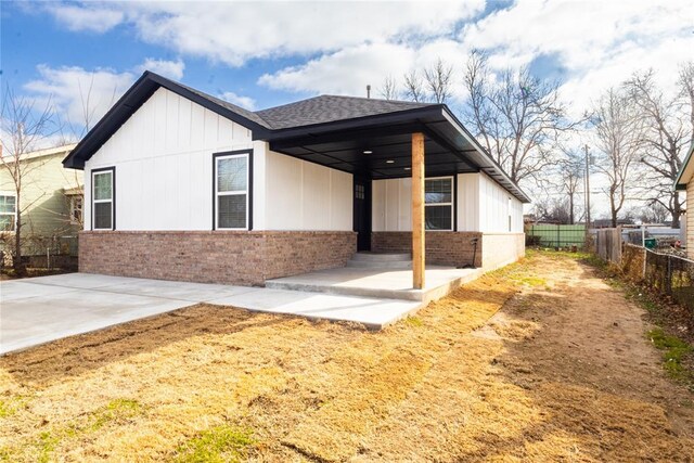 2824 SW 31st St, Oklahoma City, OK 73119 - back of house with brick siding, roof with shingles, and board and batten siding