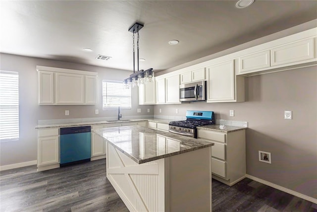 2824 SW 31st St, Oklahoma City, OK 73119 - kitchen featuring appliances with stainless steel finishes, light stone countertops, white cabinets, dark wood-type flooring, and recessed lighting