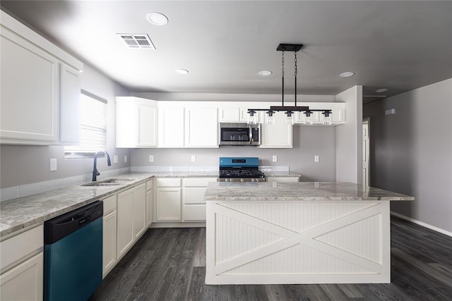 2824 SW 31st St, Oklahoma City, OK 73119 - kitchen with appliances with stainless steel finishes, dark wood-type flooring, light stone counters, white cabinetry, and recessed lighting
