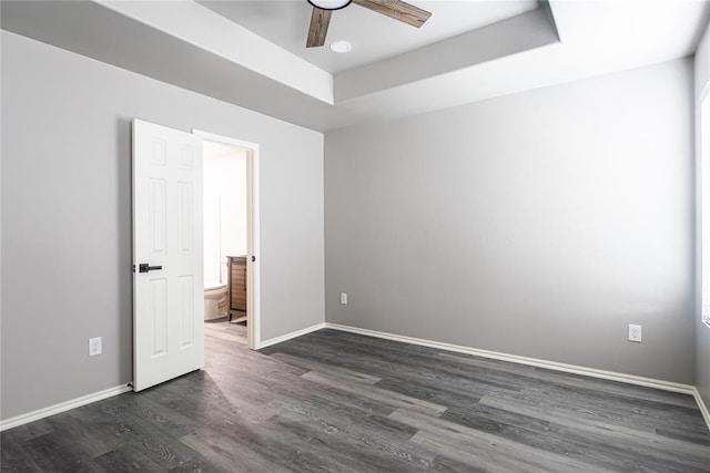 2824 SW 31st St, Oklahoma City, OK 73119 - empty room with dark wood-type flooring, ceiling fan, and a tray ceiling
