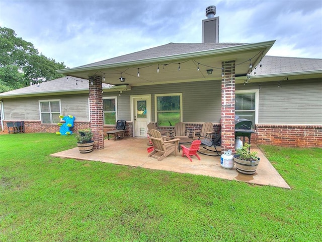 21945 N Fork Rd, Luther, OK 73054 - back of property with a patio area, a lawn, brick siding, and a shingled roof