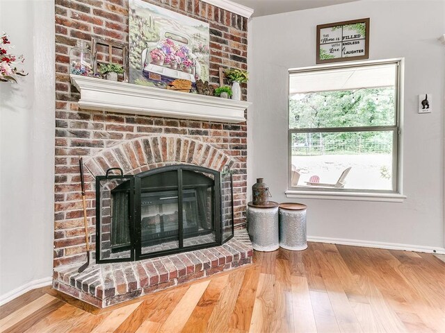 21945 N Fork Rd, Luther, OK 73054 - detailed view of a brick fireplace and wood finished floors