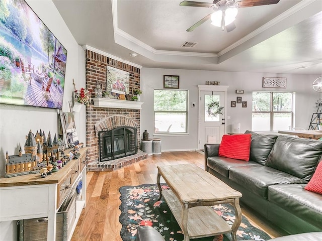 21945 N Fork Rd, Luther, OK 73054 - living area with a tray ceiling, light wood-style floors, plenty of natural light, a ceiling fan, and crown molding