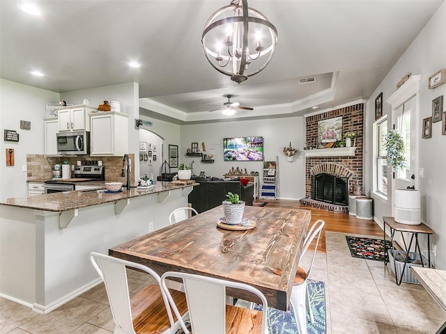 21945 N Fork Rd, Luther, OK 73054 - dining space featuring a chandelier, a tray ceiling, light tile patterned floors, ceiling fan, and recessed lighting