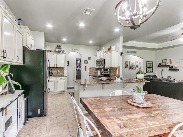 21945 N Fork Rd, Luther, OK 73054 - dining room featuring arched walkways, recessed lighting, a chandelier, crown molding, and ceiling fan
