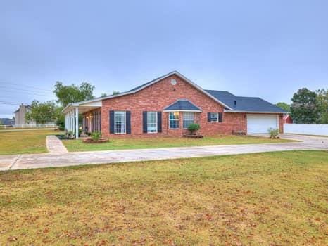 23 Lake Ln, Shawnee, OK 74804 - ranch-style house featuring driveway, a front lawn, and a garage
