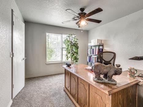 23 Lake Ln, Shawnee, OK 74804 - home office with a ceiling fan, light carpet, and a textured ceiling