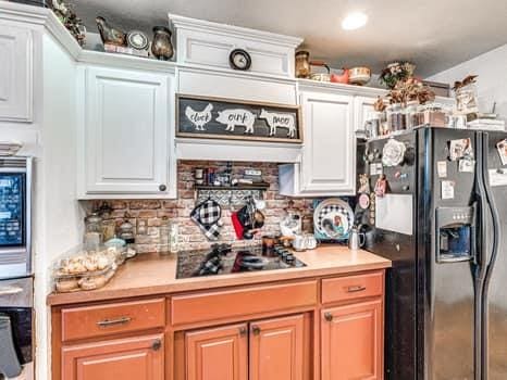 23 Lake Ln, Shawnee, OK 74804 - kitchen with black appliances, white cabinets, light countertops, and tasteful backsplash