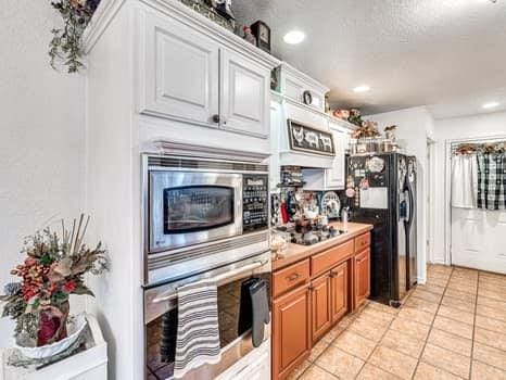 23 Lake Ln, Shawnee, OK 74804 - kitchen featuring stainless steel appliances, light tile patterned floors, recessed lighting, and light countertops