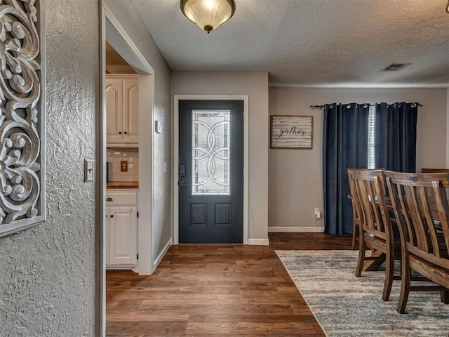 434 N Oak Ave, Hennessey, OK 73742 - entrance foyer with wood finished floors, a textured ceiling, and a textured wall