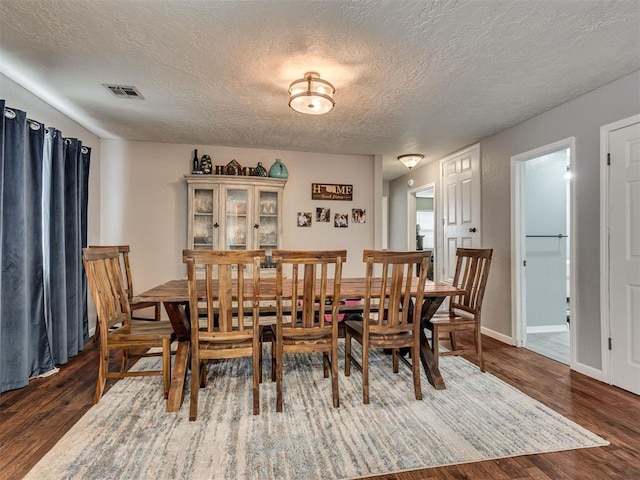 434 N Oak Ave, Hennessey, OK 73742 - dining room featuring a textured ceiling and dark wood finished floors