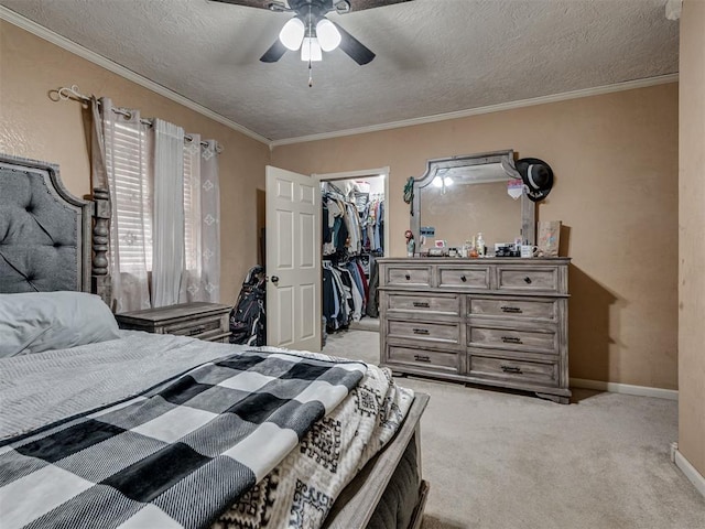 434 N Oak Ave, Hennessey, OK 73742 - bedroom featuring light colored carpet, a walk in closet, ornamental molding, a textured ceiling, and a closet