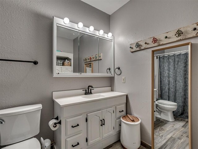 434 N Oak Ave, Hennessey, OK 73742 - bathroom with vanity, wood finished floors, a textured wall, and a shower with curtain