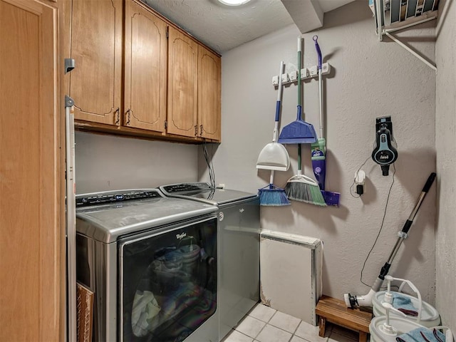 434 N Oak Ave, Hennessey, OK 73742 - washroom featuring washer and clothes dryer, cabinet space, and light tile patterned floors