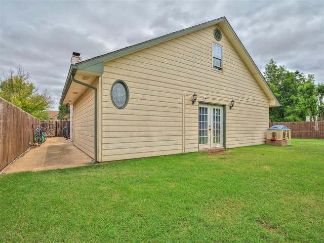 434 N Oak Ave, Hennessey, OK 73742 - rear view of house featuring french doors, a chimney, a fenced backyard, and a patio area