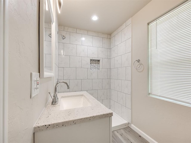 3609 S Quapah Ave, Oklahoma City, OK 73119 - bathroom with wood finished floors, vanity, a tile shower, and recessed lighting