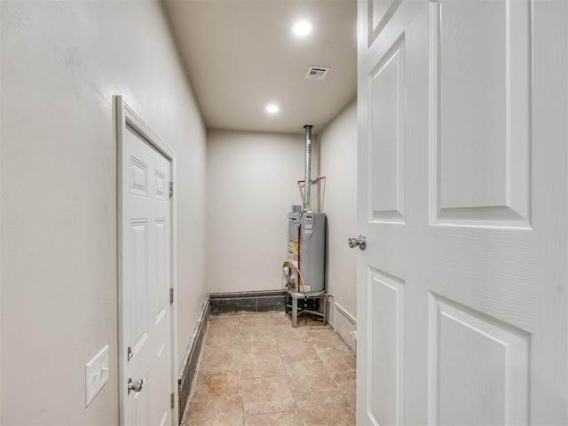 3609 S Quapah Ave, Oklahoma City, OK 73119 - corridor featuring water heater, recessed lighting, and light stone finish flooring
