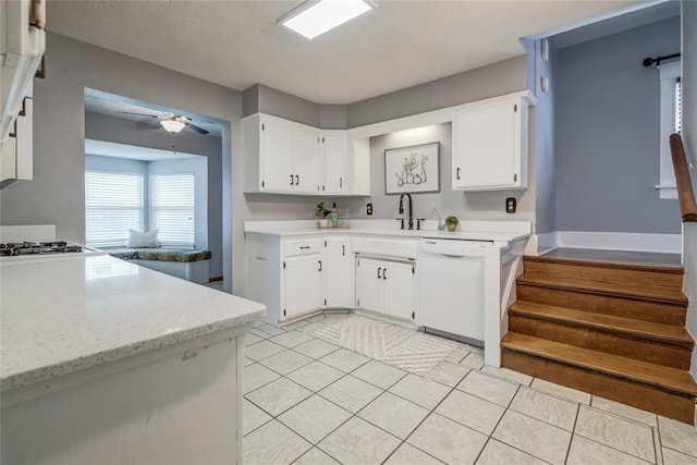 904 NW 19th St, Oklahoma City, OK 73106 - kitchen with dishwasher, white cabinets, a ceiling fan, and light tile patterned floors