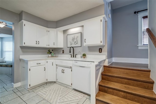 904 NW 19th St, Oklahoma City, OK 73106 - kitchen with white dishwasher, light countertops, white cabinetry, and a ceiling fan