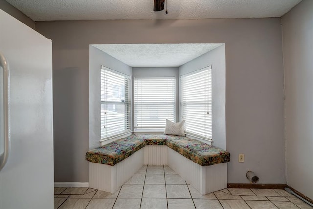 904 NW 19th St, Oklahoma City, OK 73106 - unfurnished dining area featuring a textured ceiling and light tile patterned floors