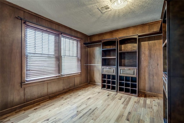 904 NW 19th St, Oklahoma City, OK 73106 - interior space with light wood finished floors, wooden walls, a textured ceiling, and ornamental molding